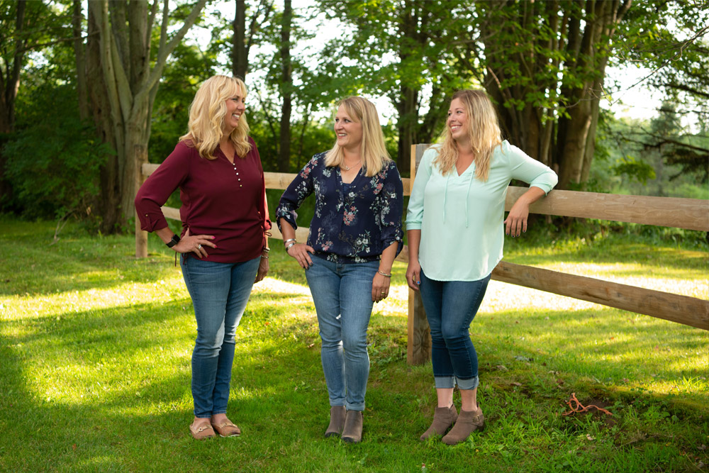 Trainers Amy Hanssen, Virginia Beaton and Jenna Striffler laugh together