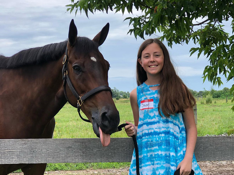summer2 Camper poses with horse at summer horse camp